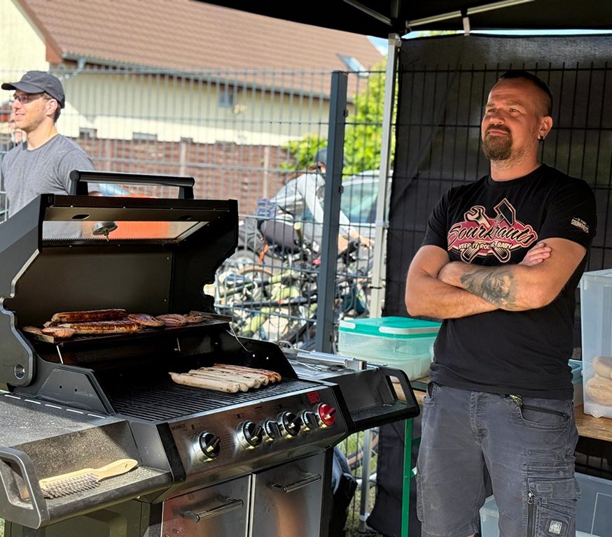 a man standing in front of a grill